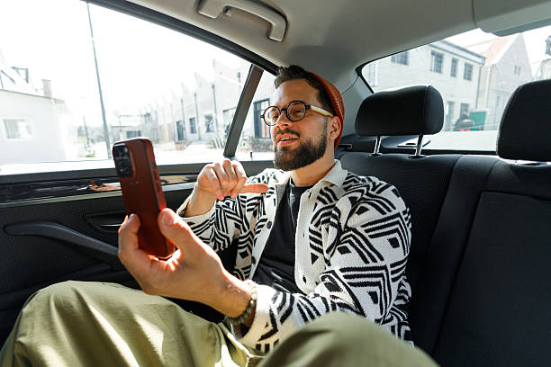 istock Man Having Video Call in Car Backseat 2215487310