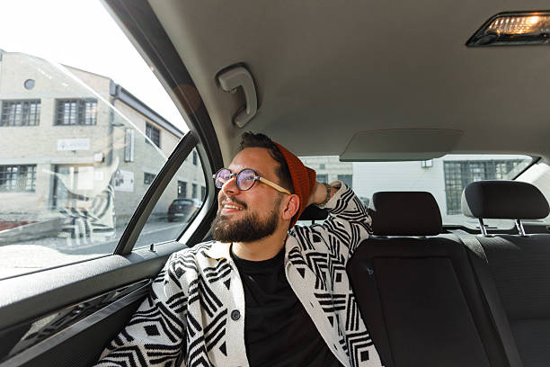 istock Cheerful Man Relaxing in Car Backseat 2215487315