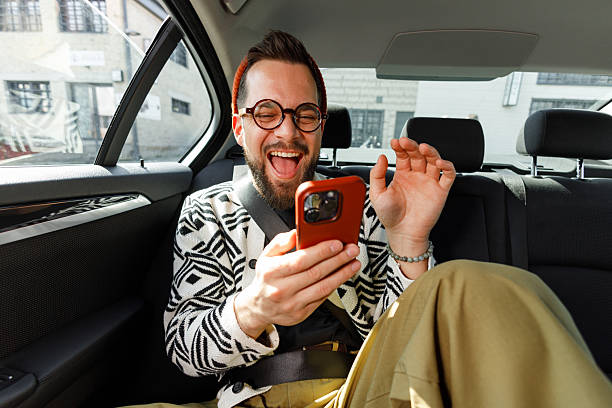 istock Man Having Video Call in Car Backseat 2215487317