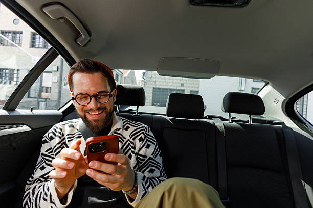 istock Man Having Video Call in Car Backseat 2215487318