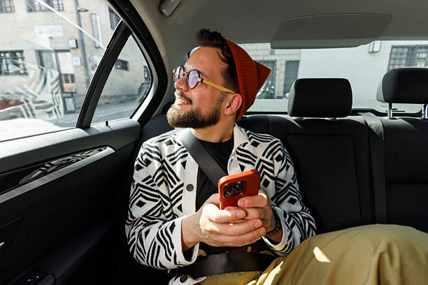 istock Man Having Video Call in Car Backseat 2215487319