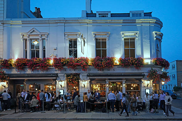 London, UK - Sept. 19, 2024:  Outdoor restaurant or pub tables on sidewalk on a summer night