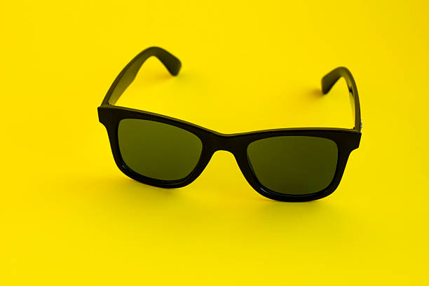 istock Stylish black color sunglasses on yellow 2215489060