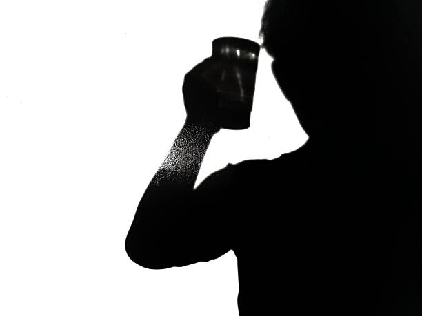 istock Silhouette of a man holding a glass 2215491076