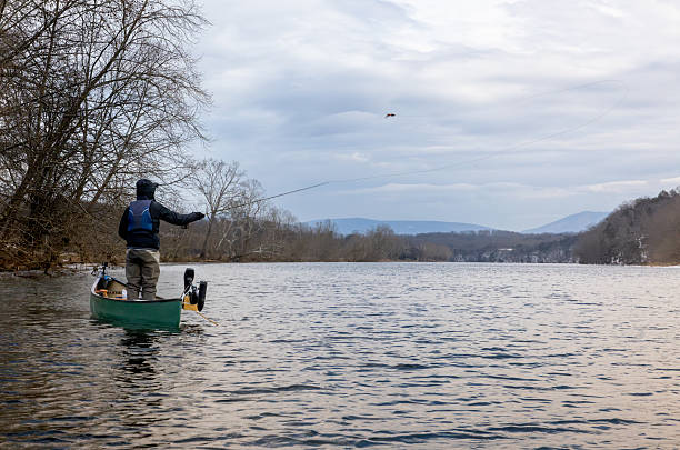 istock Musky Fly Fisherman Casting Large Fly From a Canoe 2215493218