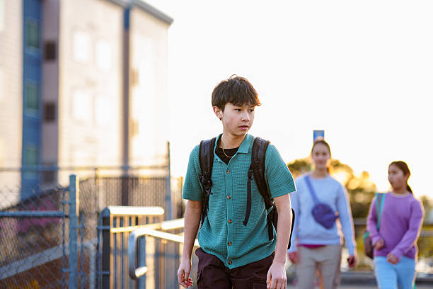 istock Teenage boy walking on train station platform 2215493793