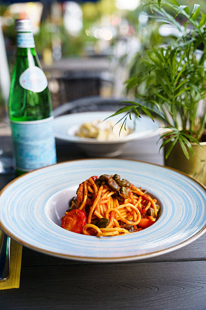 istock Spaghetti alla puttanesca with olives and cherry tomatoes 2215494251