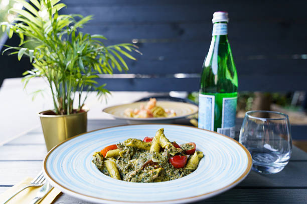 istock Penne pasta with pesto sauce and cherry tomatoes 2215494258