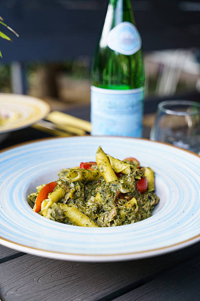 istock Penne pasta with pesto sauce and cherry tomatoes 2215494264