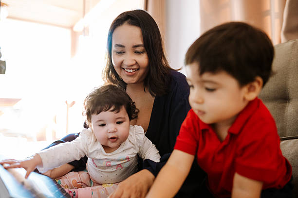 istock Mother and two kids sitting at the table 2215496839