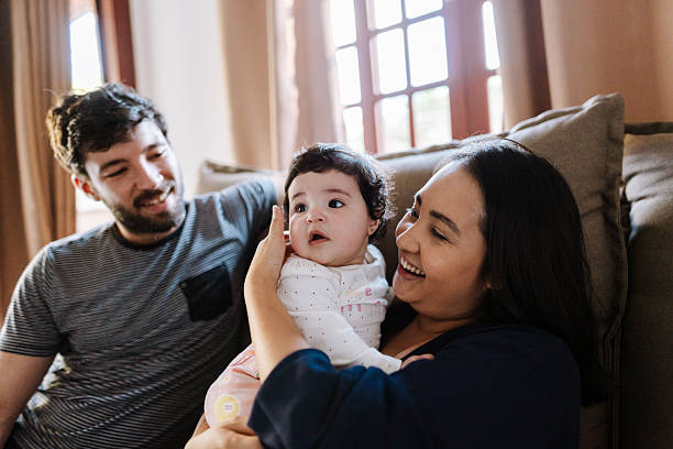 istock Father and mother holding baby together 2215496921