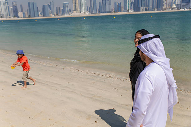 istock Middle Eastern couple is talking and having fun at the beach. 2215499411