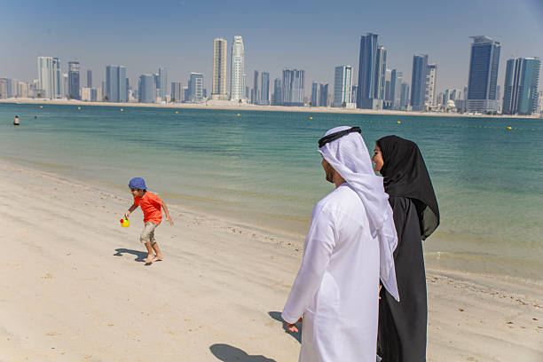 istock Middle Eastern couple is talking and having fun at the beach. 2215499442