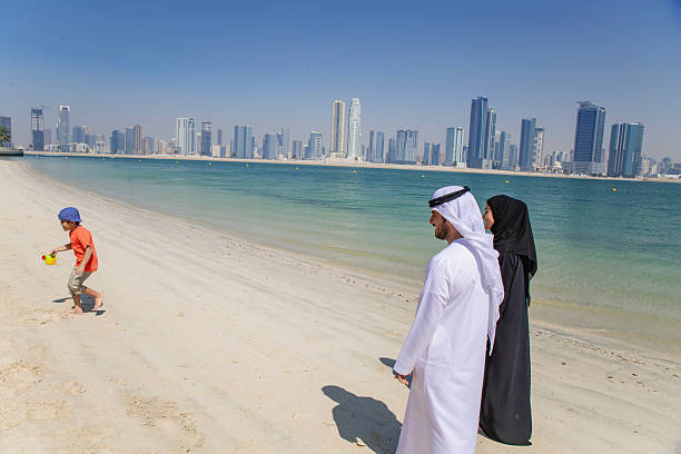 istock Middle Eastern couple is talking and having fun at the beach. 2215499452