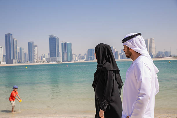 istock Middle Eastern couple is talking and having fun at the beach. 2215499597