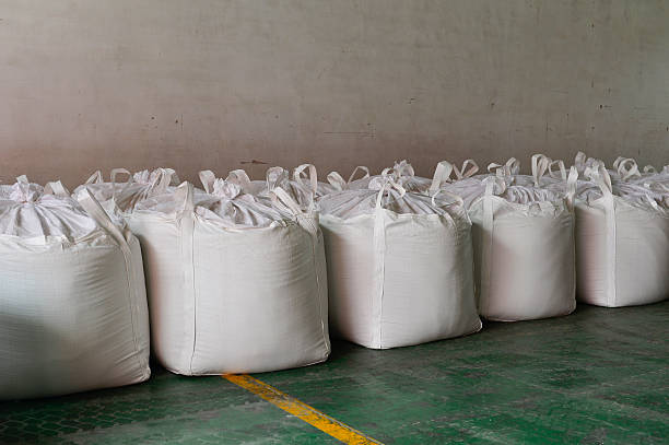istock Many rows of plastic white sacks with goods are in big warehouse 2215500368