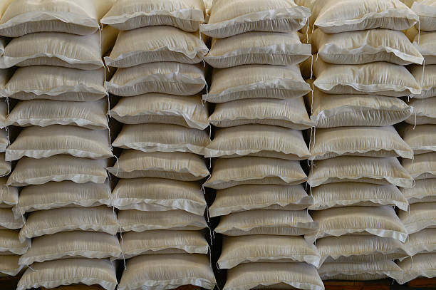 istock Many rows of plastic white sacks with goods are in big warehouse 2215500401