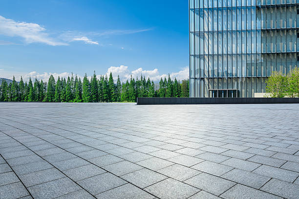 istock Empty square floor and glass wall with green forest on a sunny day 2215501222