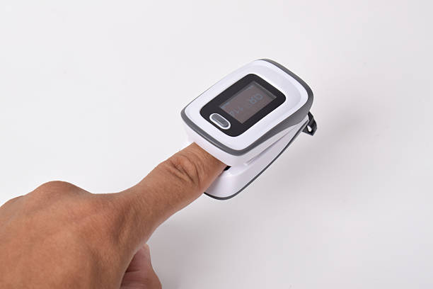 istock Pulse oximeter with hand of patient on white background 2215504227