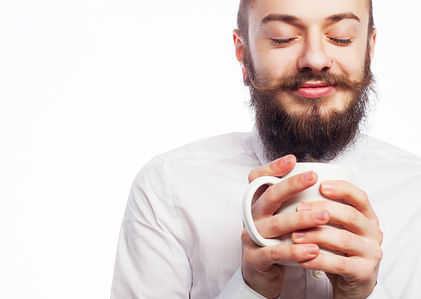 young man drinking a cup of coffee or tea isolated white background