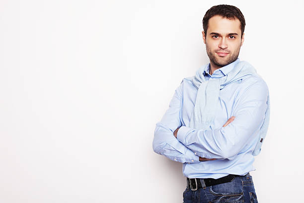 istock happy young man in blue shirt. 2215507850
