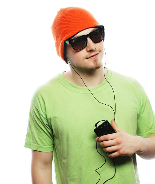 Low angle view of fashionable boy wearing sunglasses and cap during winter. Close-up of trendy male child is outdoors on sunny day. He is against clear sky.