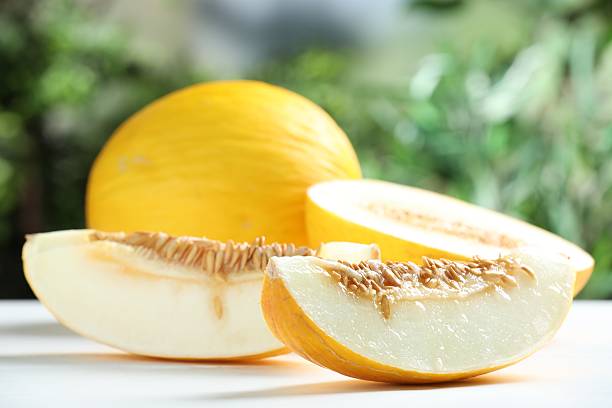 istock Fresh ripe melons on white table outdoors, closeup 2215513520