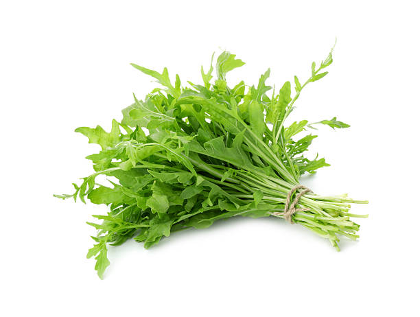 istock Bunch of fresh arugula leaves isolated on white 2215513565