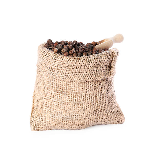 istock Burlap sack with allspice and scoop isolated on white 2215514526