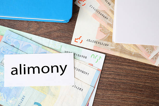 istock Alimony. Euro banknotes, blank card and notebook on wooden table, top view 2215514931