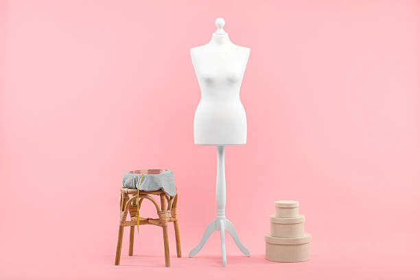 istock Mannequin, measuring tape and stool on pink background 2215515688