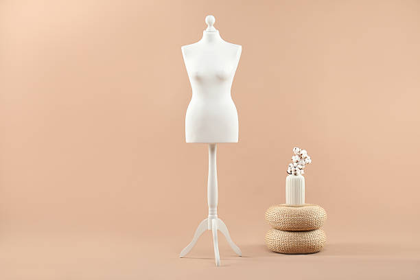 istock Female mannequin and vase on beige background 2215515726