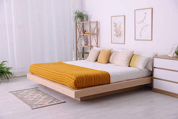 istock Large bed near window in room. Stylish bedroom interior 2215515843