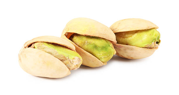 istock Three tasty pistachio nuts isolated on white 2215517212