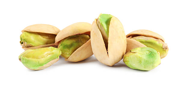 istock Many tasty pistachio nuts isolated on white 2215517249