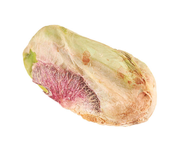 istock One peeled pistachio nut isolated on white 2215517261