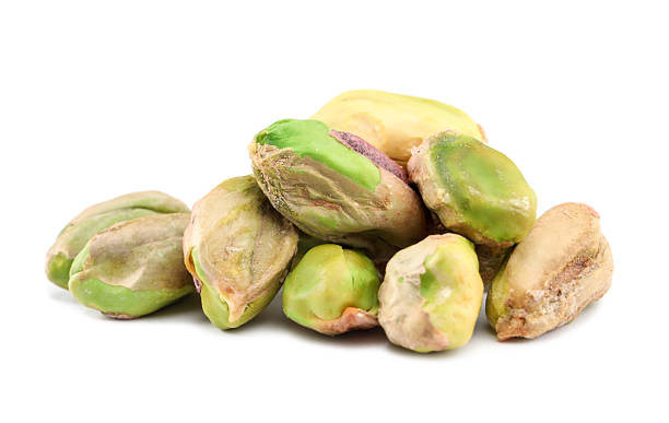 istock Tasty peeled pistachio nuts isolated on white 2215517296