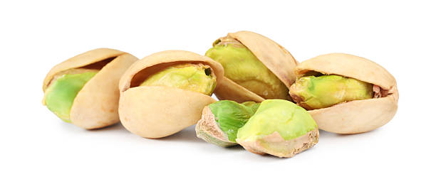 istock Many tasty pistachio nuts isolated on white 2215517298