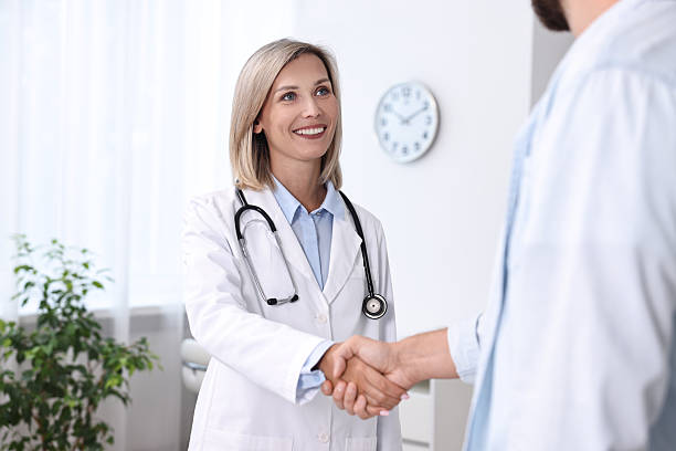 istock Doctor shaking hands with patient in hospital 2215517350