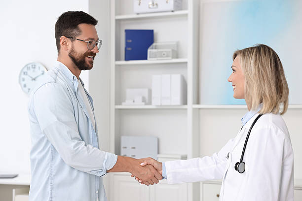 istock Doctor shaking hands with patient in hospital 2215517354