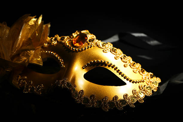 istock Beautiful golden carnival mask on black background, closeup 2215517631