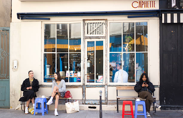 Paris, France: Young women sitting outside Caphette, a Vietnamese fusion cafe on Rue Neuve Popincourt, just off Oberkampf in the 11th arrondissement.