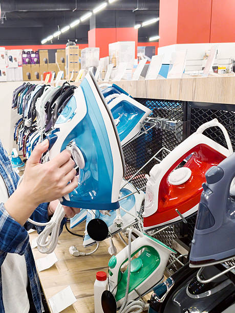 Iron in hands woman in store