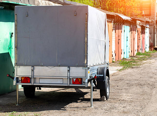 istock Gray single axle tarpaulin trailer for transporting cargo for a passenger car, copy space for text 2215520809