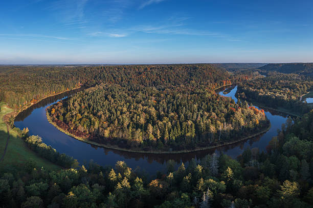 Sunrise at river Gauja in autumn next to Sigulda, Latvia. Photo taken on an early morning from a drone