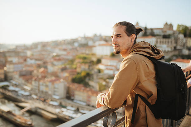 istock Man using a smart phone on the famous Porto bridge. 2215523654