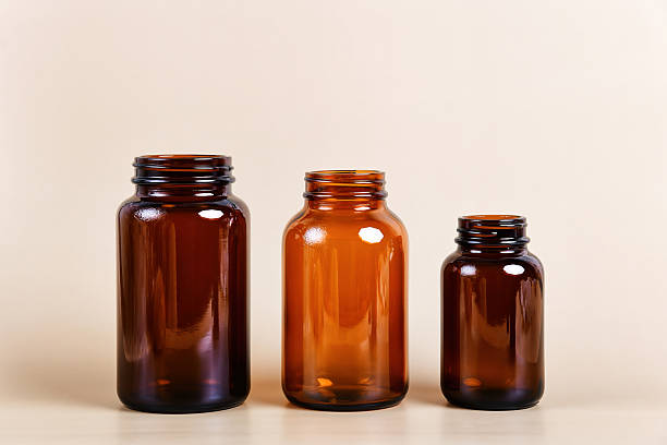 istock Three amber glass bottles of varying sizes stand in a row 2215526537