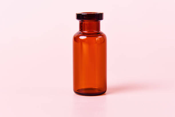 istock An empty amber glass bottle is displayed against a soft pink background 2215526574