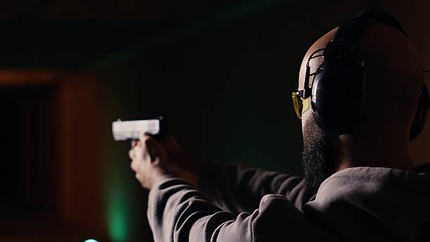 istock Man shooting targets with pistol, learning to operate handgun in close quarters 2215526849