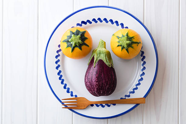 A summer vegetable character made with colorful zucchini and eggplant.